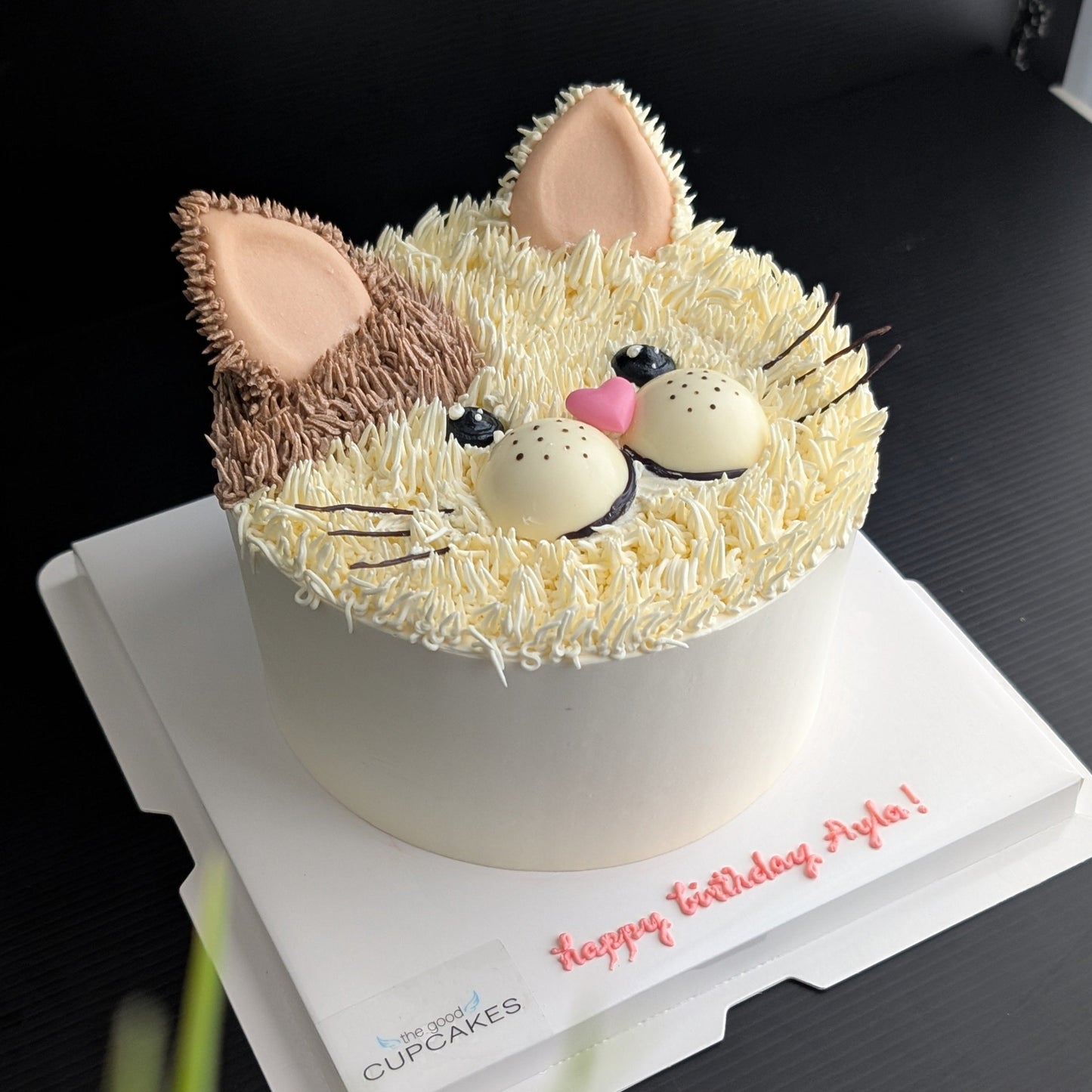 Cat face birthday cake with cream and brown buttercream fur, pink heart nose and ears, whiskers, low-sugar cake Singapore