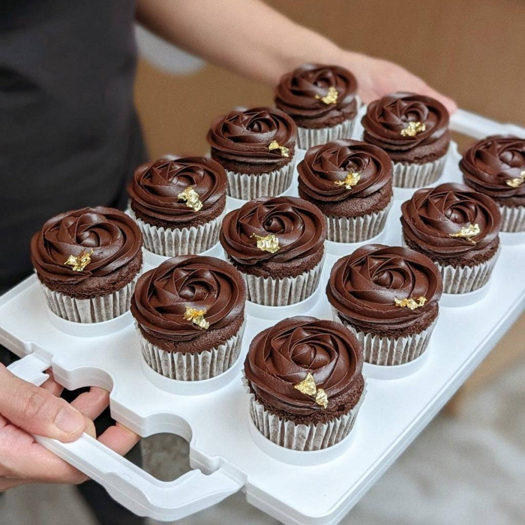 Tray of 12 chocolate cupcakes with rose-piped dark chocolate buttercream and gold leaf, 150 calories each
