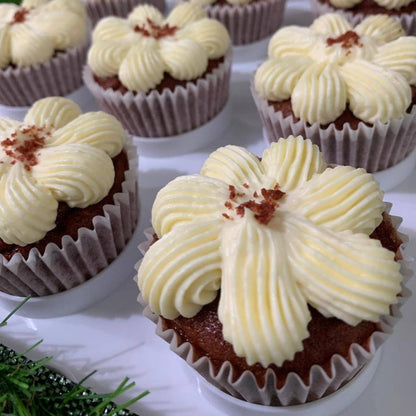 Red velvet cupcakes with flower-piped cream cheese frosting and red velvet crumble, 150 calories each