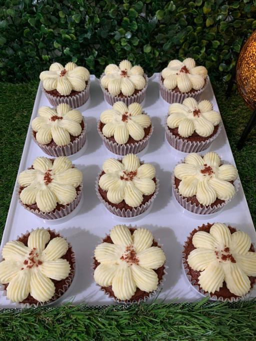 Red velvet cupcakes with flower-piped cream cheese frosting and red velvet crumble, 150 calories each