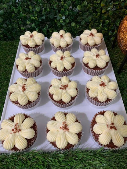 Red velvet cupcakes with flower-piped cream cheese frosting and red velvet crumble, 150 calories each