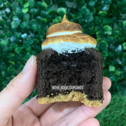 Cross-section of s'mores cupcake showing chocolate sponge, graham cracker base and toasted marshmallow frosting, only 150 calories