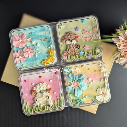 Floral bento boxed cakes with hand-piped buttercream flowers on pastel painted backgrounds, healthy low-sugar mini cakes Singapore