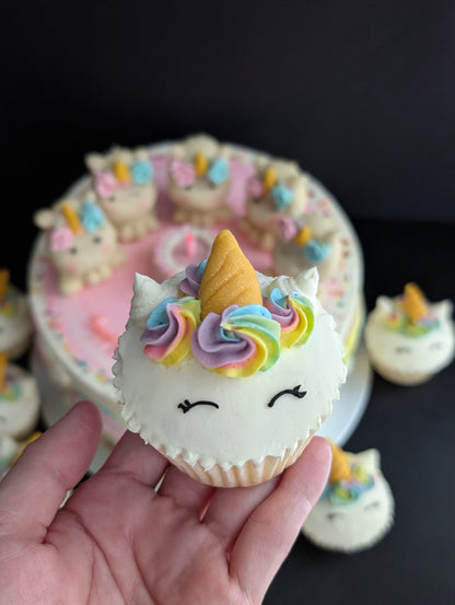 Close-up of hand holding a mini unicorn-topped cake, hand-sculpted fondant-free unicorn design — The Good Cupcakes Singapore