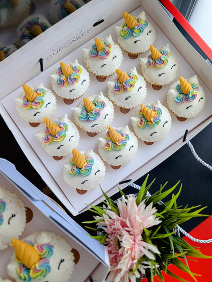 Overhead view of Rainbow Unicorn cupcakes gift box styled with fresh flowers, hand-piped buttercream designs — The Good Cupcakes Singapore
