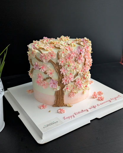 Cherry blossom Sakura tree cake with hand-piped pink buttercream flowers on white cake, healthy low-sugar floral birthday cake Singapore
