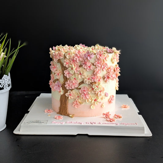 Cherry blossom Sakura tree cake with hand-piped pink buttercream flowers on white cake, healthy low-sugar floral birthday cake Singapore