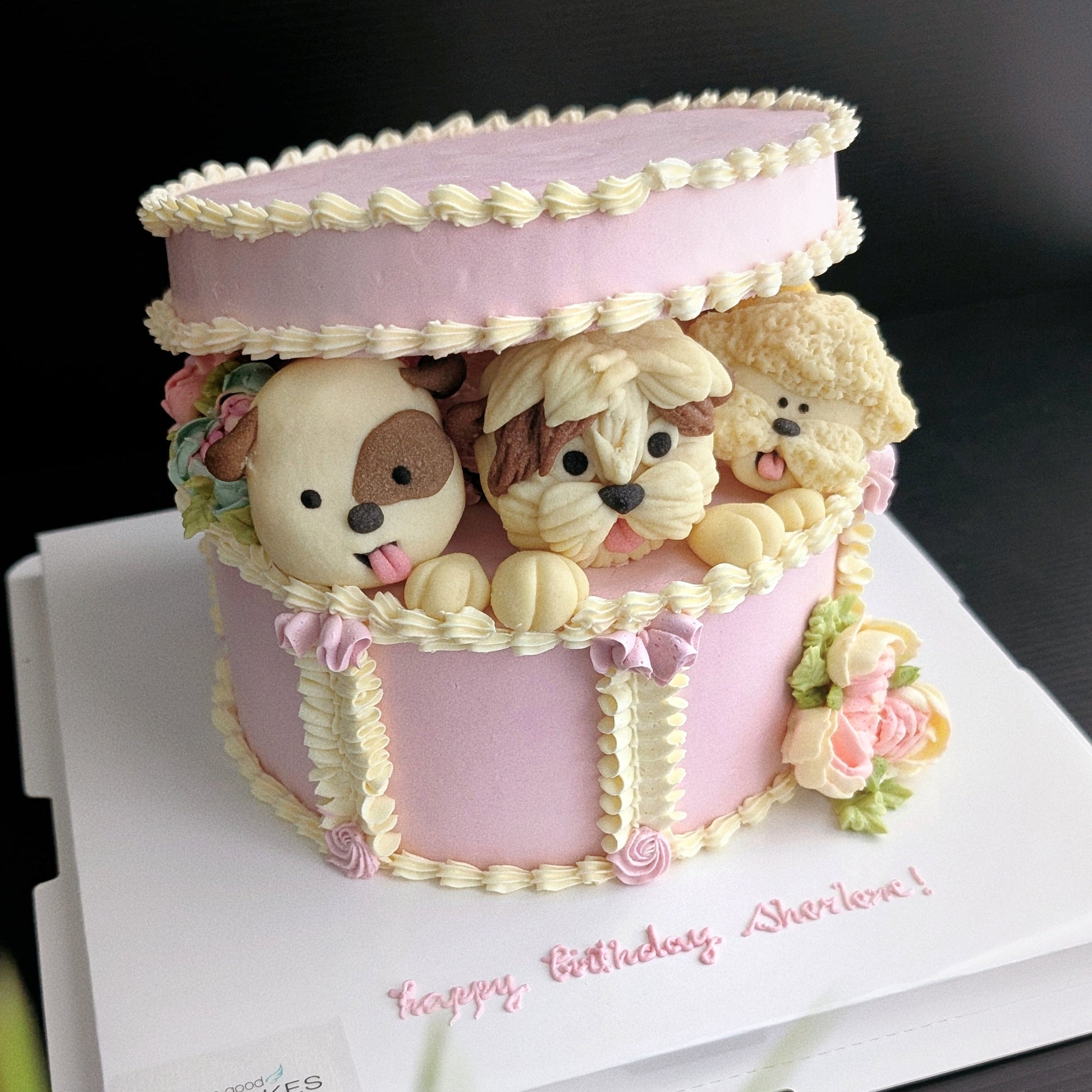 Gift box with 3 puppies in a hand-piped white and pink cake gift box, healthy low-sugar birthday cake