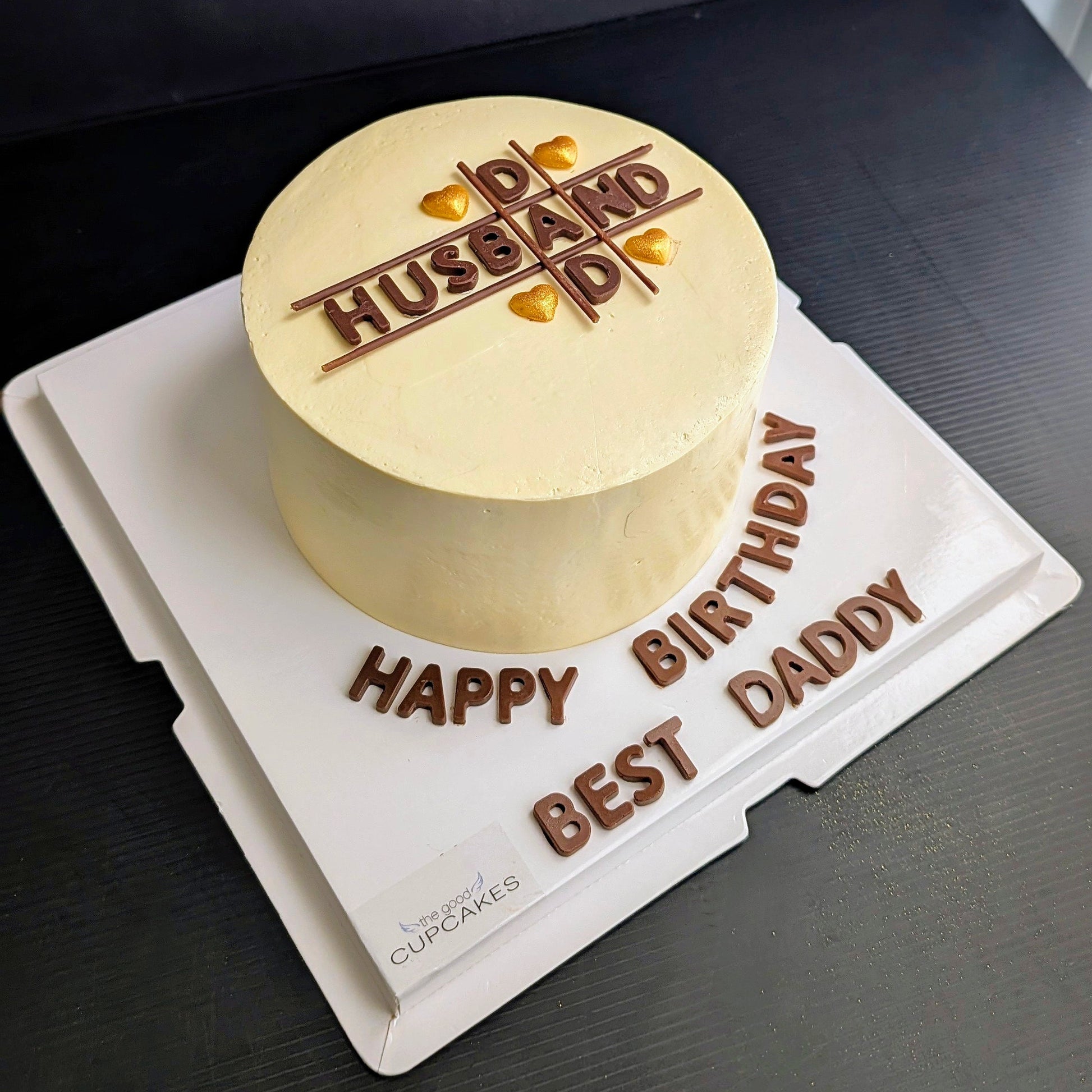 Husband Dad birthday cake with chocolate piped lettering grid design and gold heart sprinkles on cream buttercream, custom men's cake Singapore