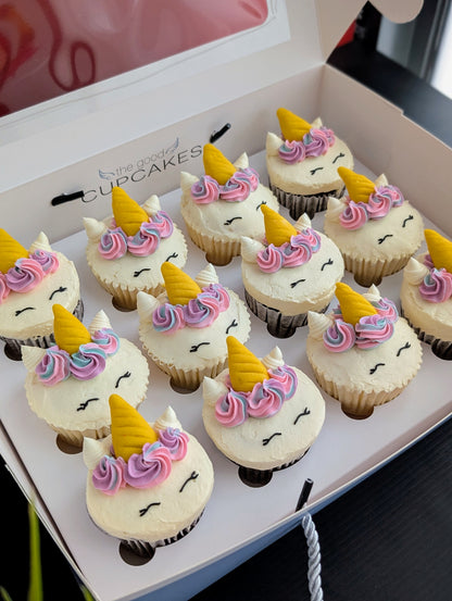 Tray of Rainbow Unicorn cupcakes viewed from above, colourful hand-piped buttercream unicorn faces — The Good Cupcakes Singapore