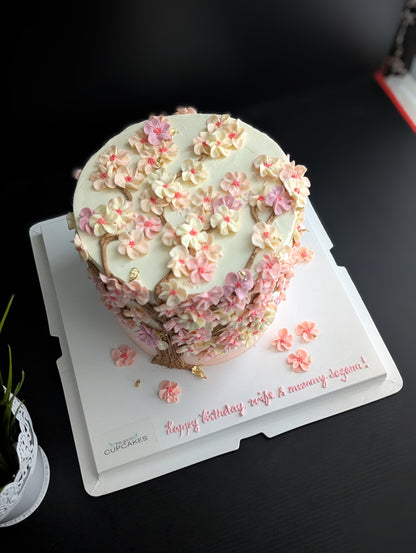 Cherry blossom Sakura tree cake with hand-piped pink buttercream flowers on white cake, healthy low-sugar floral birthday cake Singapore