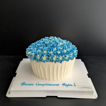 Giant cupcake cake shaped like oversized cupcake with blue hydrangea buttercream top and white ribbed base, low-sugar celebration cake Singapore