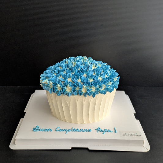Giant cupcake cake shaped like oversized cupcake with blue hydrangea buttercream top and white ribbed base, low-sugar celebration cake Singapore