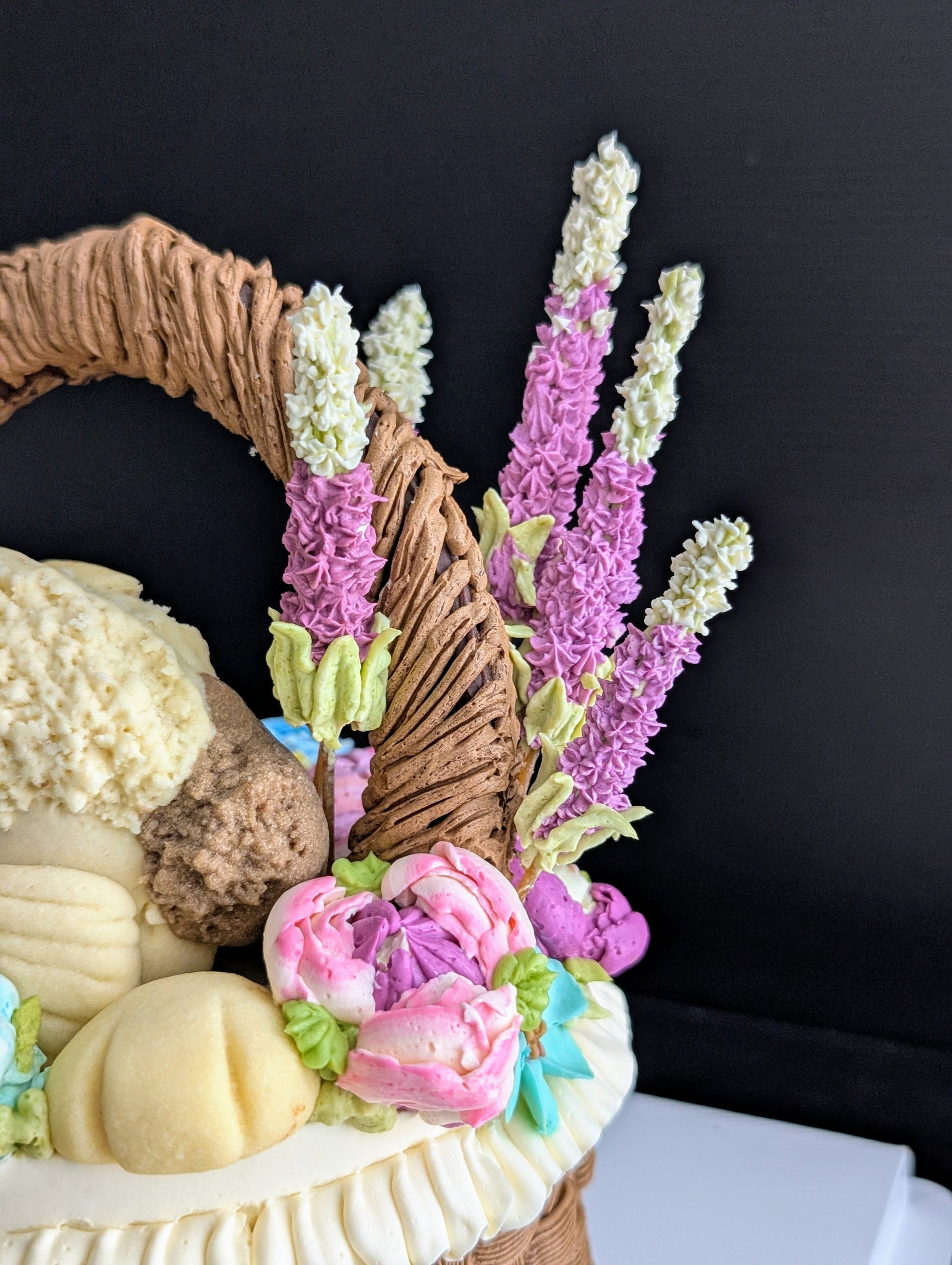 Floral basket cake with a sculpted puppy surrounded by hand-piped purple, pink and yellow flowers healthy low-sugar birthday cake