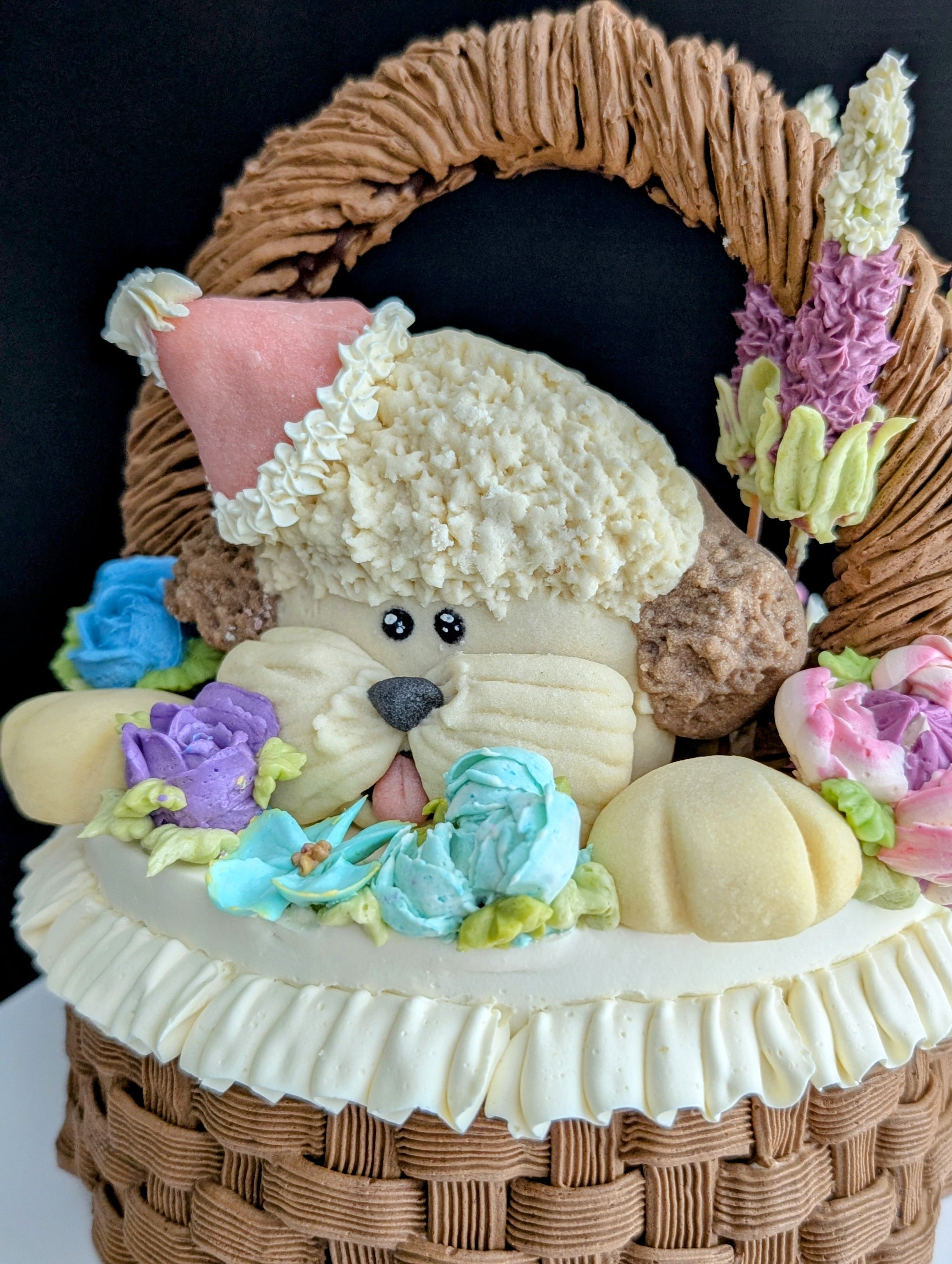 Floral basket cake with a sculpted puppy surrounded by hand-piped purple, pink and yellow flowers healthy low-sugar birthday cake