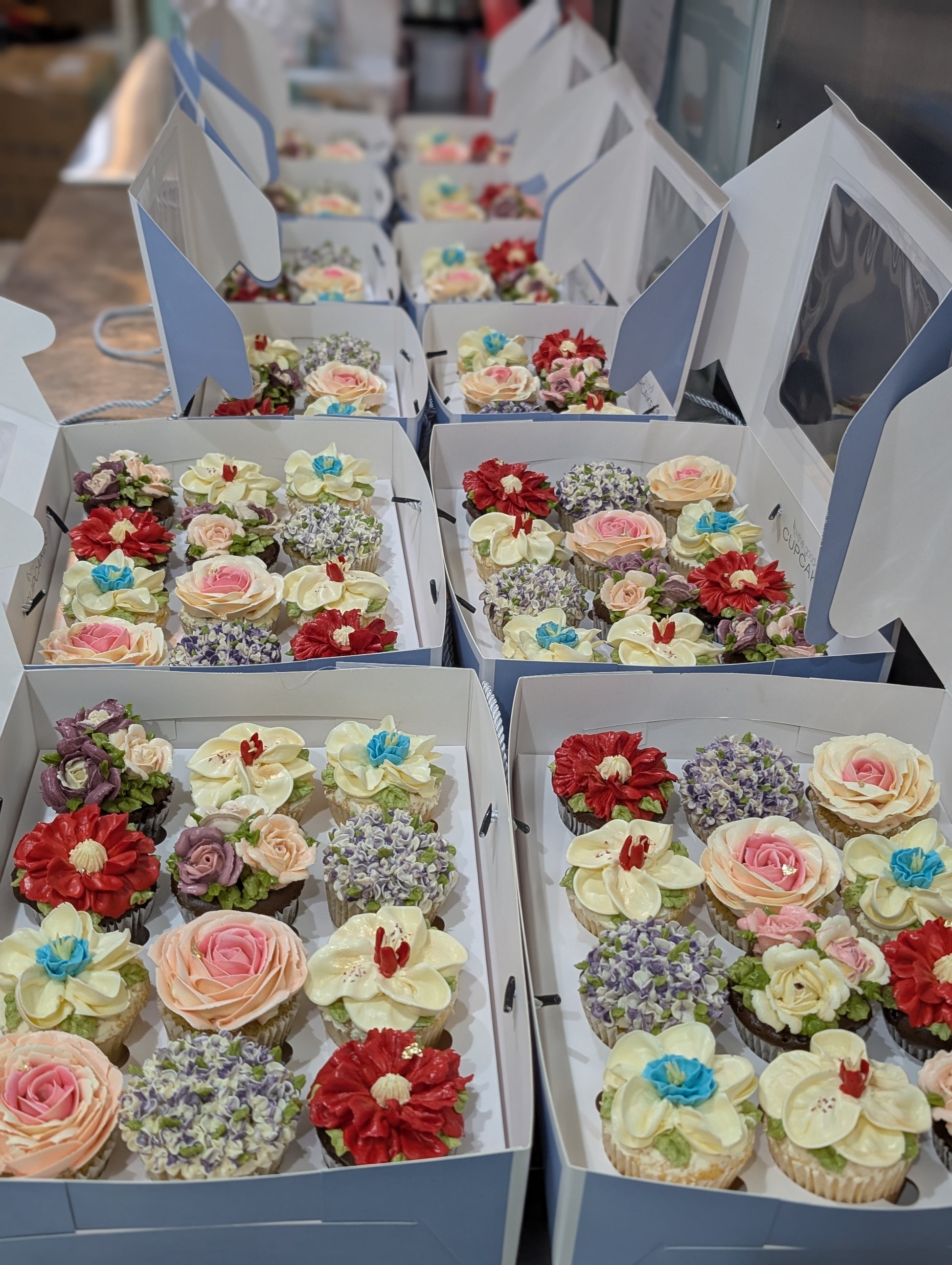 Bulk floral cupcake gift boxes for corporate events, hand-piped buttercream flowers, 150 calories each, The Good Cupcakes Singapore