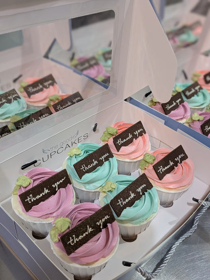 Boxes of pastel rose buttercream cupcakes with handcrafted chocolate "thank you" plaques in purple, yellow, pink and blue, The Good Cupcakes Singapore

