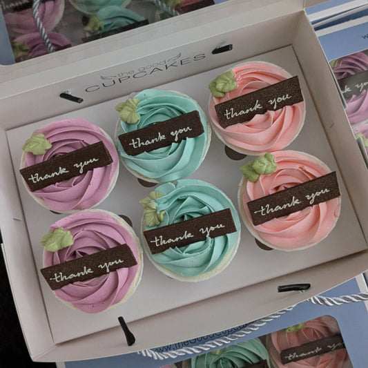 Box of 6 pastel rose buttercream cupcakes with handcrafted chocolate "thank you" plaques in purple, yellow, pink and blue, The Good Cupcakes Singapore


