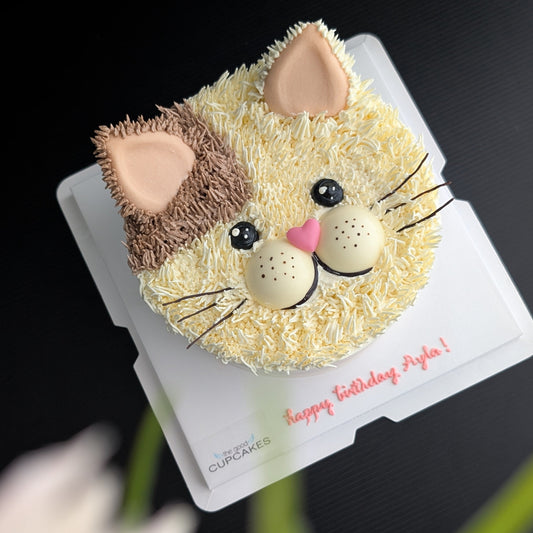 Cat face birthday cake with cream and brown buttercream fur, pink heart nose and ears, whiskers, low-sugar cake Singapore