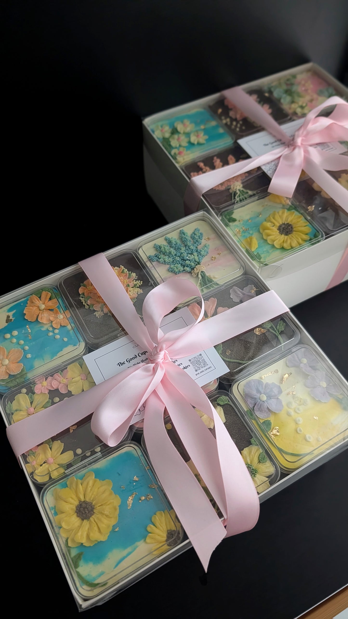 Floral bento boxed cakes with hand-piped buttercream flowers on pastel painted backgrounds, healthy low-sugar mini cakes Singapore