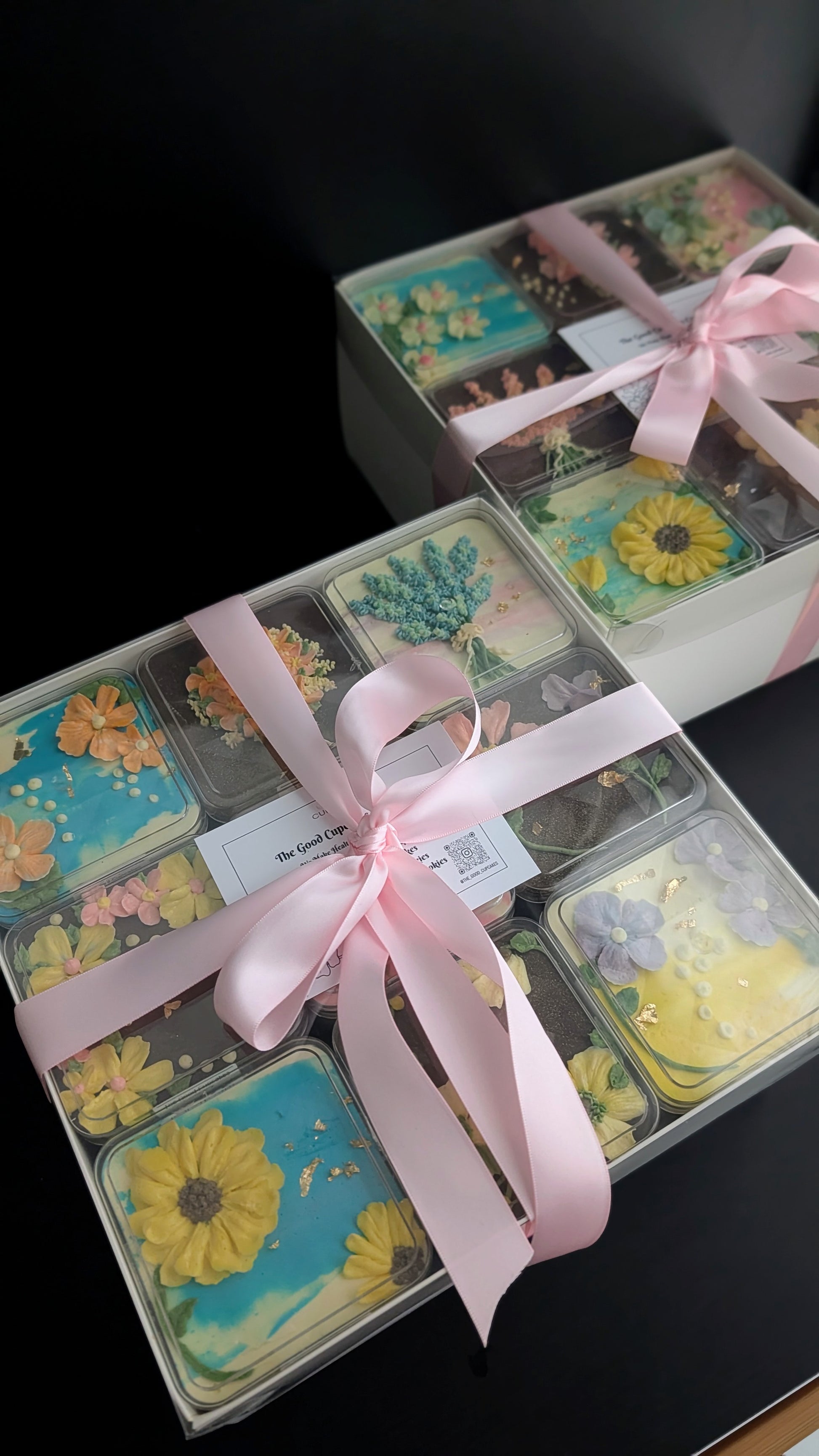 Floral bento boxed cakes with hand-piped buttercream flowers on pastel painted backgrounds, healthy low-sugar mini cakes Singapore
