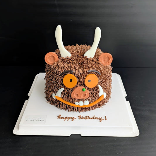Whimsical forest monster cake with hand-piped buttercream and googly eyes, The Good Cupcakes Singapore