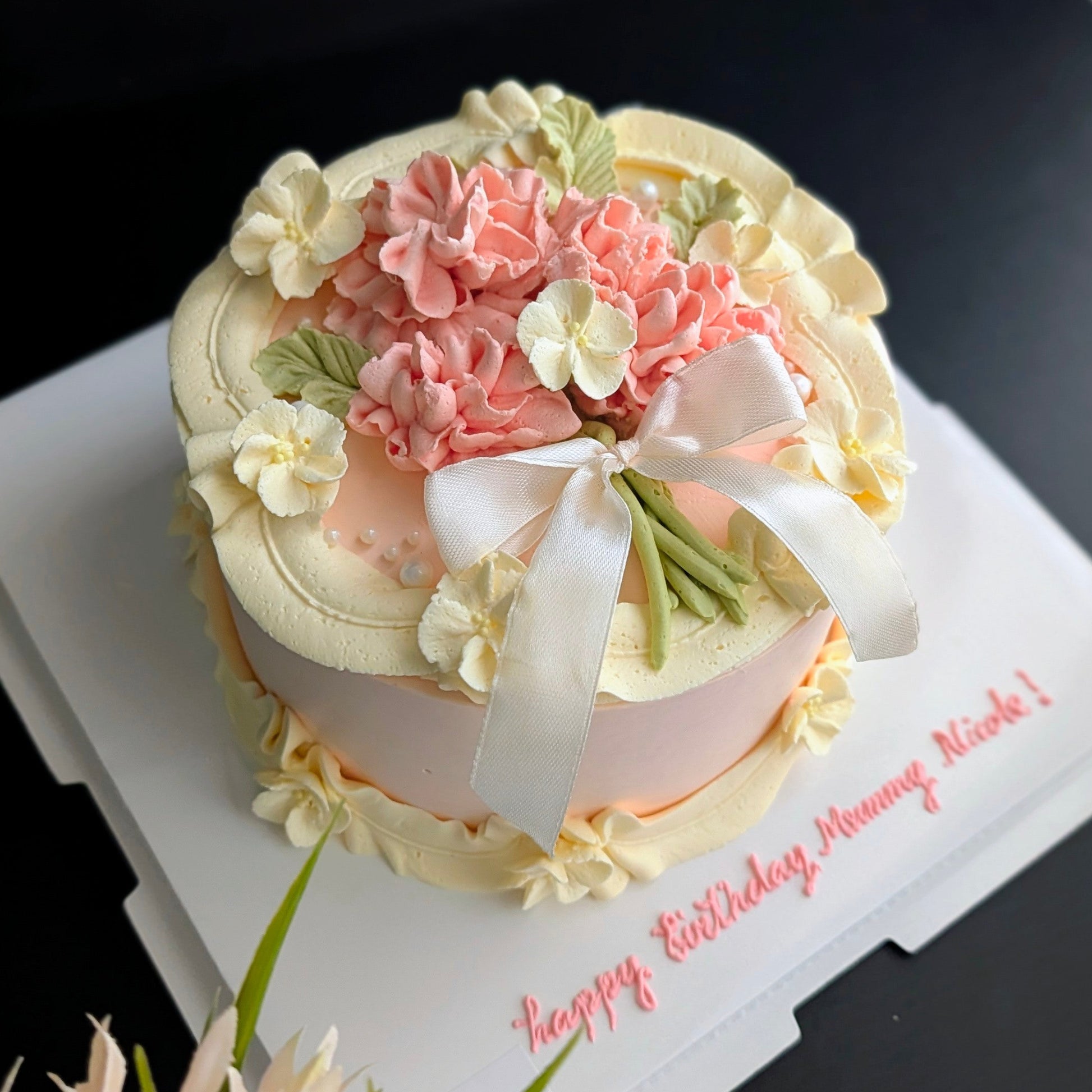 Round cake topped with hand-piped buttercream carnations, healthy low-calorie floral birthday cake