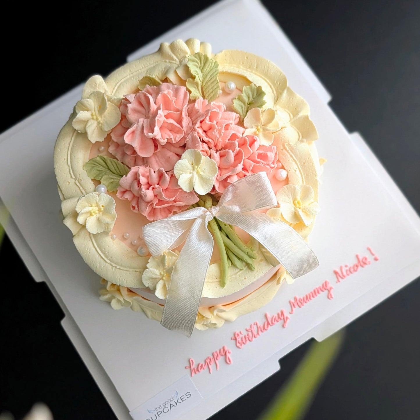 Round cake topped with hand-piped buttercream carnations, healthy low-calorie floral birthday cake