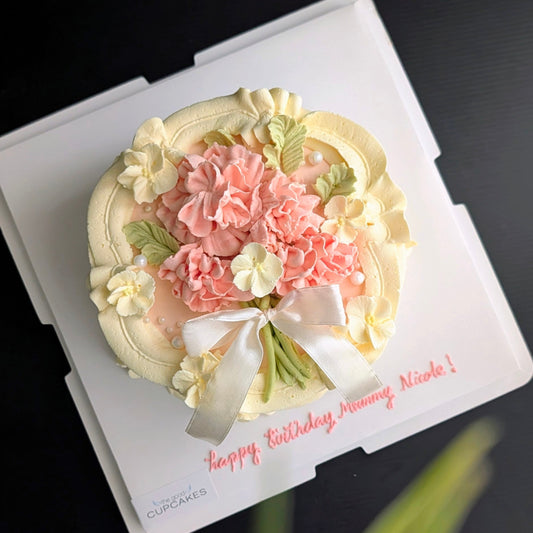 Round cake topped with hand-piped buttercream carnations, healthy low-calorie floral birthday cake
