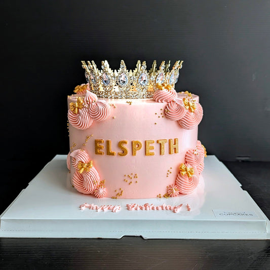 Pink birthday cake with gold crown topper, pink striped buttercream rosettes, gold letter name and gold star sprinkles, princess birthday cake Singapore