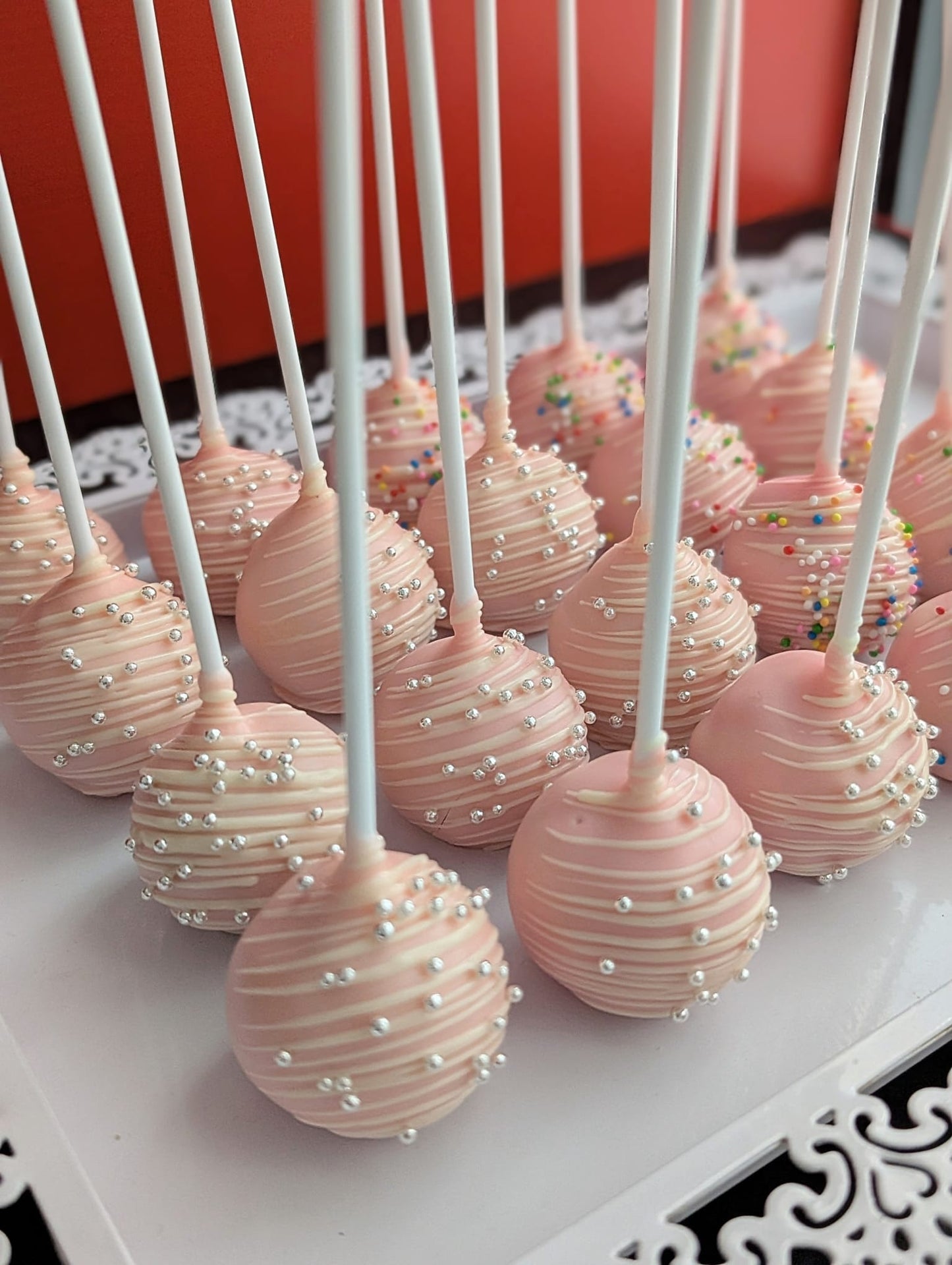 Cake pops with white chocolate drizzle and silver pearl sprinkles – low-calorie handcrafted treats by The Good Cupcakes