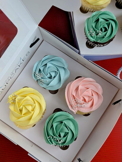 Set of 4 chocolate cupcakes with pastel rose buttercream in blue, pink, yellow and teal with silver pearls, low sugar healthier dessert gift box