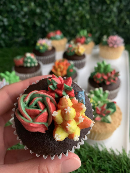 Hand holding a single succulent floral cupcake, red rose and green cactus buttercream piping detail — The Good Cupcakes Singapore