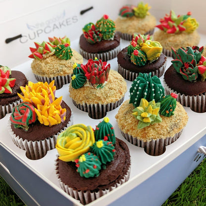 Overhead view of succulent buttercream cupcake gift box, chocolate cupcakes topped with yellow, orange and green piped florals — The Good Cupcakes Singapore