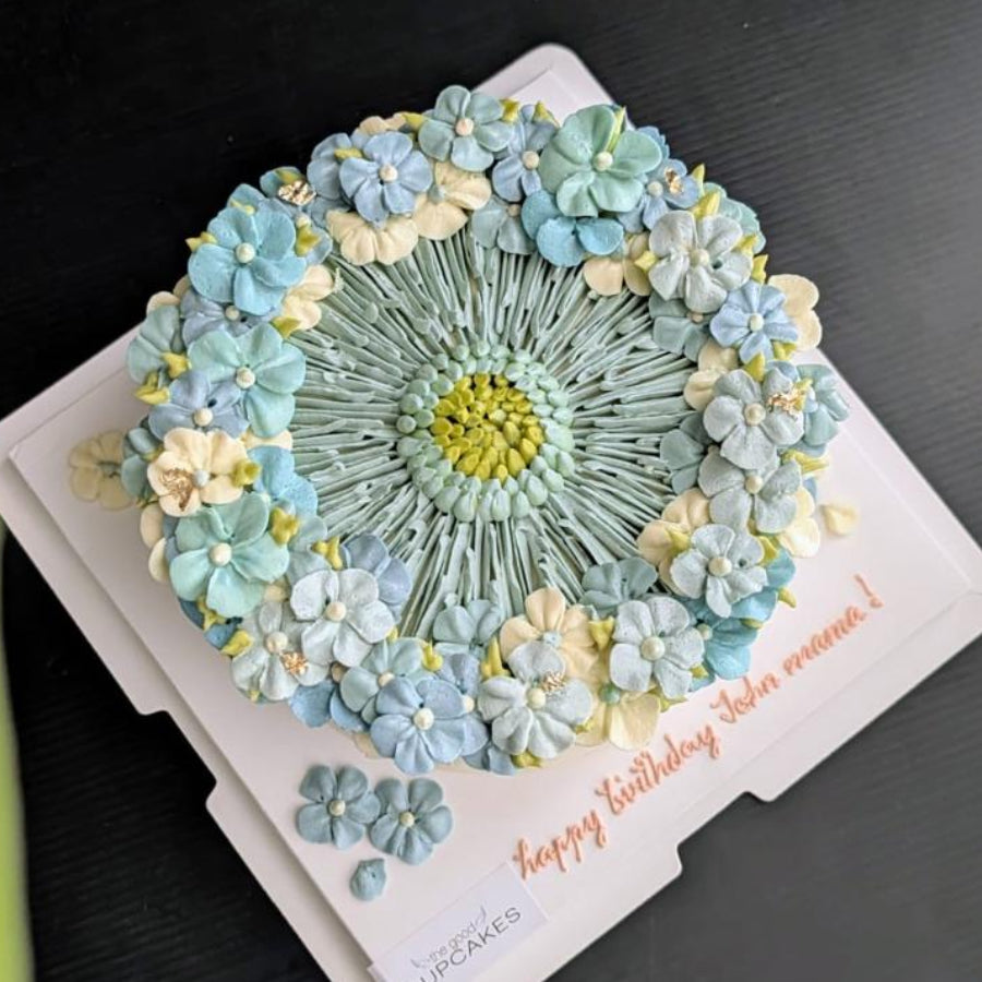 blue round-shaped floral cake with hand-piped buttercream flowers, healthy low-sugar birthday cake Singapore