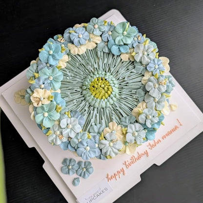blue round-shaped floral cake with hand-piped buttercream flowers, healthy low-sugar birthday cake Singapore