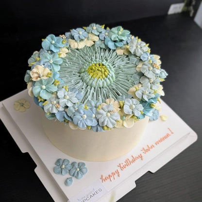 blue round-shaped floral cake with hand-piped buttercream flowers, healthy low-sugar birthday cake Singapore