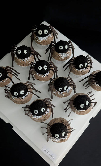 Spider cupcakes with chocolate cake ball spider topper, googly eyes, chocolate legs, and caramel buttercream with white pearl sprinkles, low-sugar Halloween cupcakes Singapore