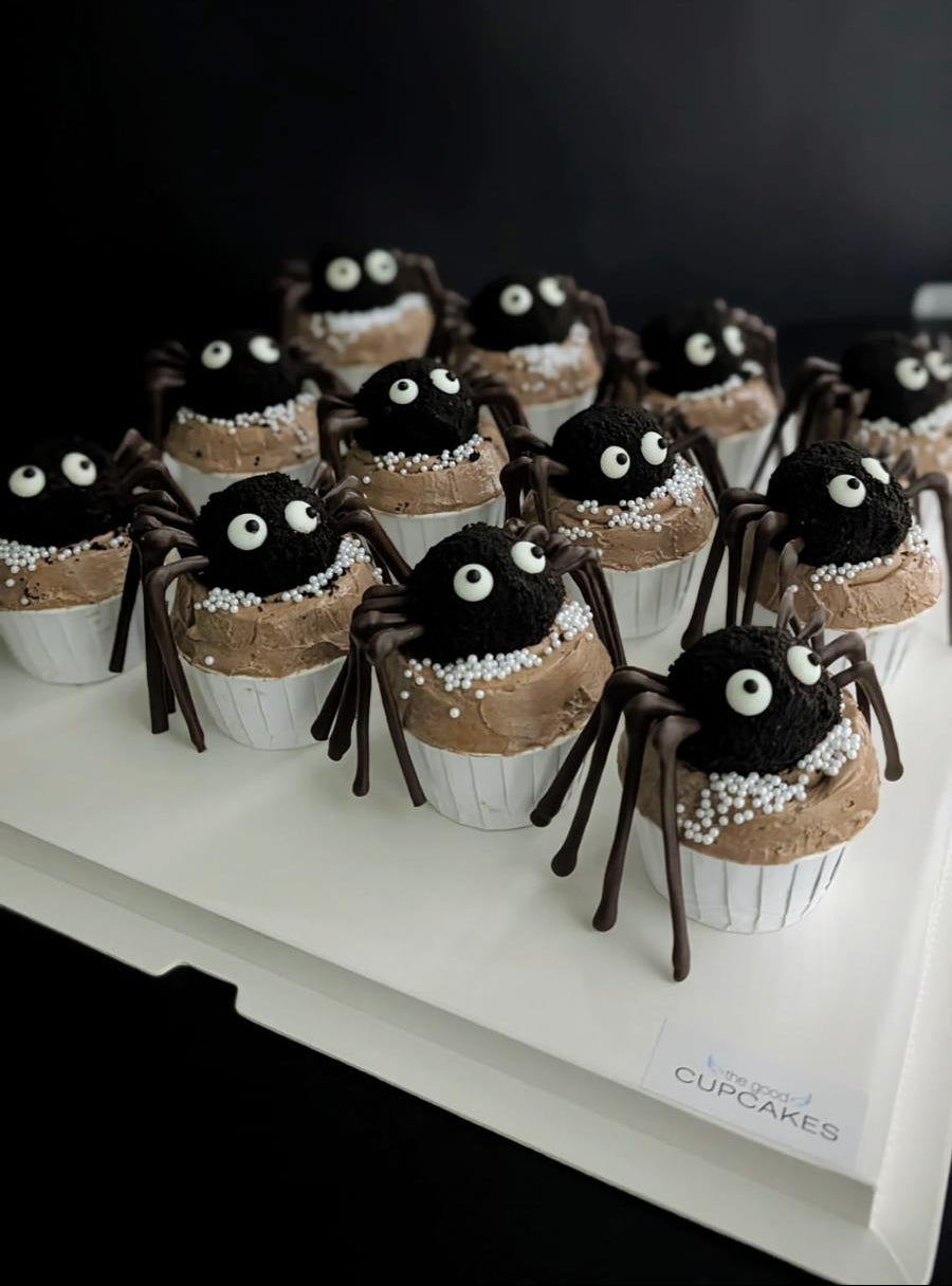Spider cupcakes with chocolate cake ball spider topper, googly eyes, chocolate legs, and caramel buttercream with white pearl sprinkles, low-sugar Halloween cupcakes Singapore