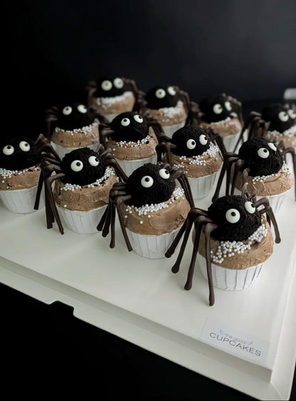 Spider cupcakes with chocolate cake ball spider topper, googly eyes, chocolate legs, and caramel buttercream with white pearl sprinkles, low-sugar Halloween cupcakes Singapore