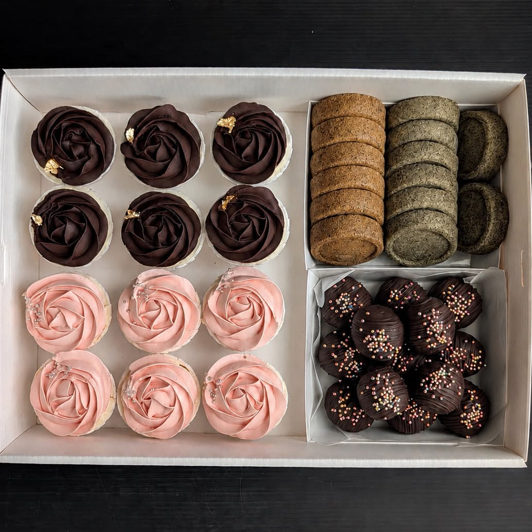 Corporate team treats box for 5–8 pax featuring dark chocolate rose cupcakes with gold leaf, pink rose cupcakes, assorted butter cookies, and dark chocolate cake truffles by The Good Cupcakes Singapore