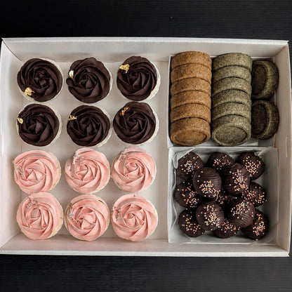 Corporate team treats box for 5–8 pax featuring dark chocolate rose cupcakes with gold leaf, pink rose cupcakes, assorted butter cookies, and dark chocolate cake truffles by The Good Cupcakes Singapore