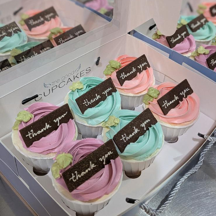 Box of 6 thank you cupcakes in pastel pink, blue and purple frosting with chocolate thank you tags