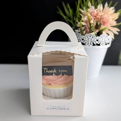 The Good Cupcakes single thank you cupcake in white gift box with handle, styled with pink flowers