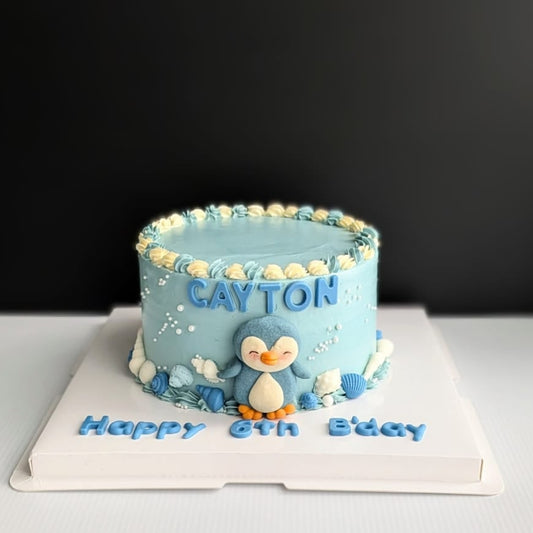 Blue ombre Penguin Cake with handcrafted shortbread cookie penguin, chocolate shell decorations and hand-piped buttercream, The Good Cupcakes Singapore