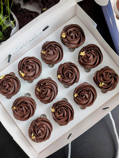 
Overhead view of 12 chocolate cupcakes with dark chocolate