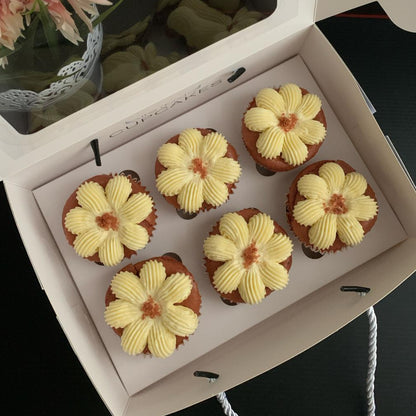Red velvet cupcakes with flower-piped cream cheese frosting and red velvet crumble, 150 calories each