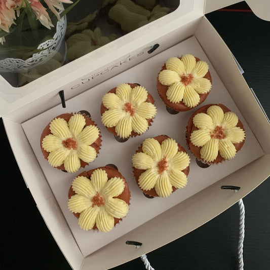 Red velvet cupcakes with flower-piped cream cheese frosting and red velvet crumble, 150 calories each