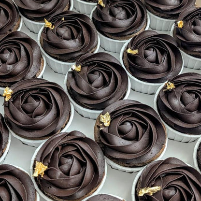 Flat lay of dark chocolate cupcakes with deep swirled rose buttercream and gold leaf, premium healthier dessert Singapore