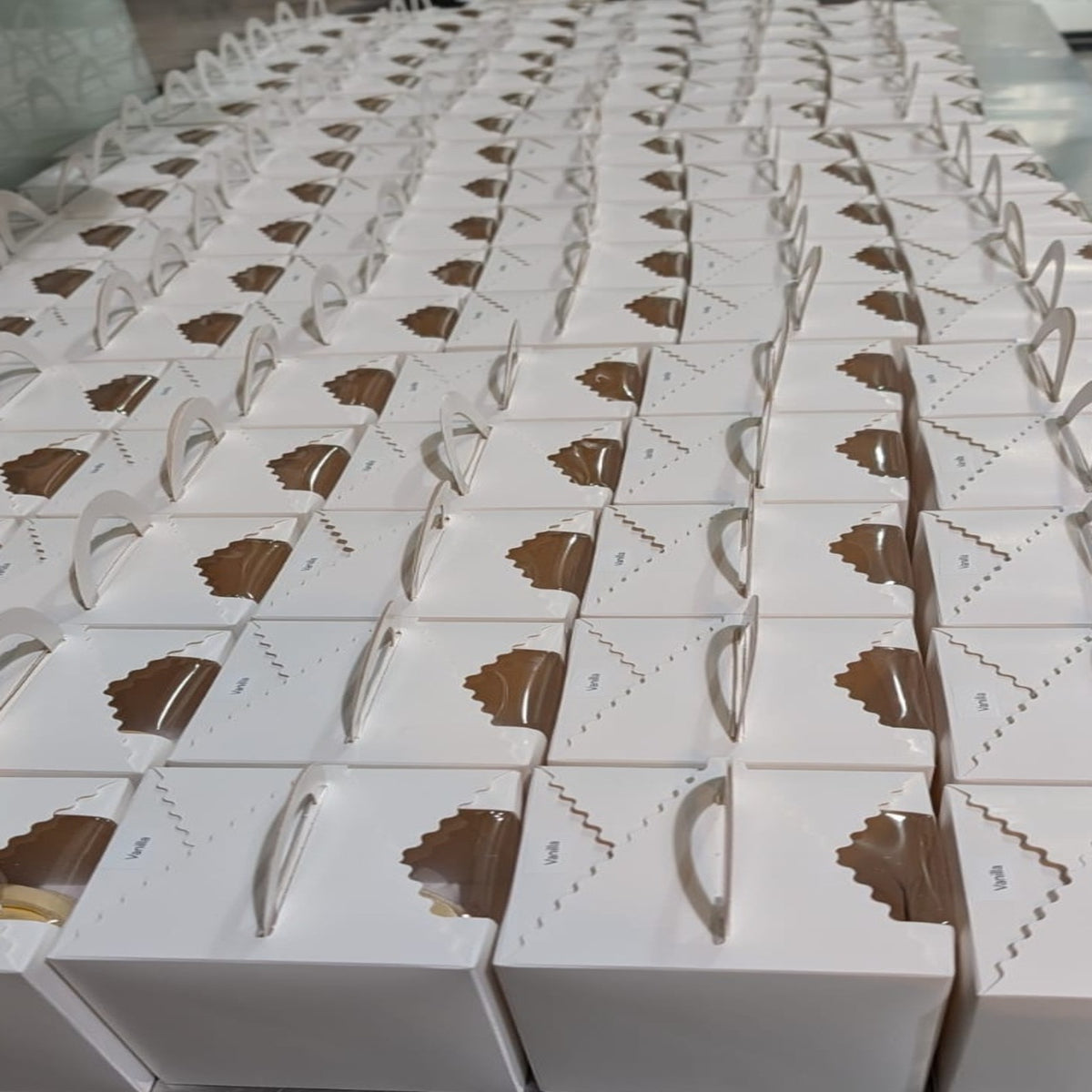 Rows of individually boxed cupcakes prepared for an 800-cupcake Singapore General Hospital order.